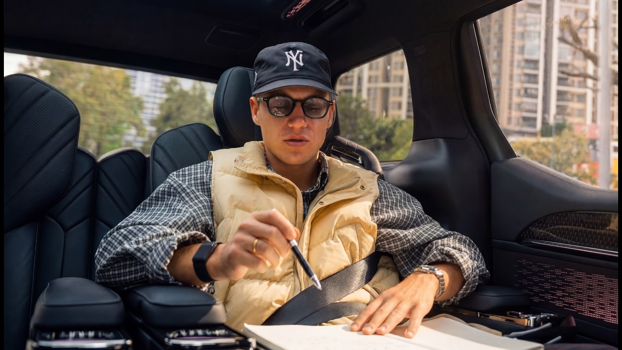 Daniel writing notes in the back of a car